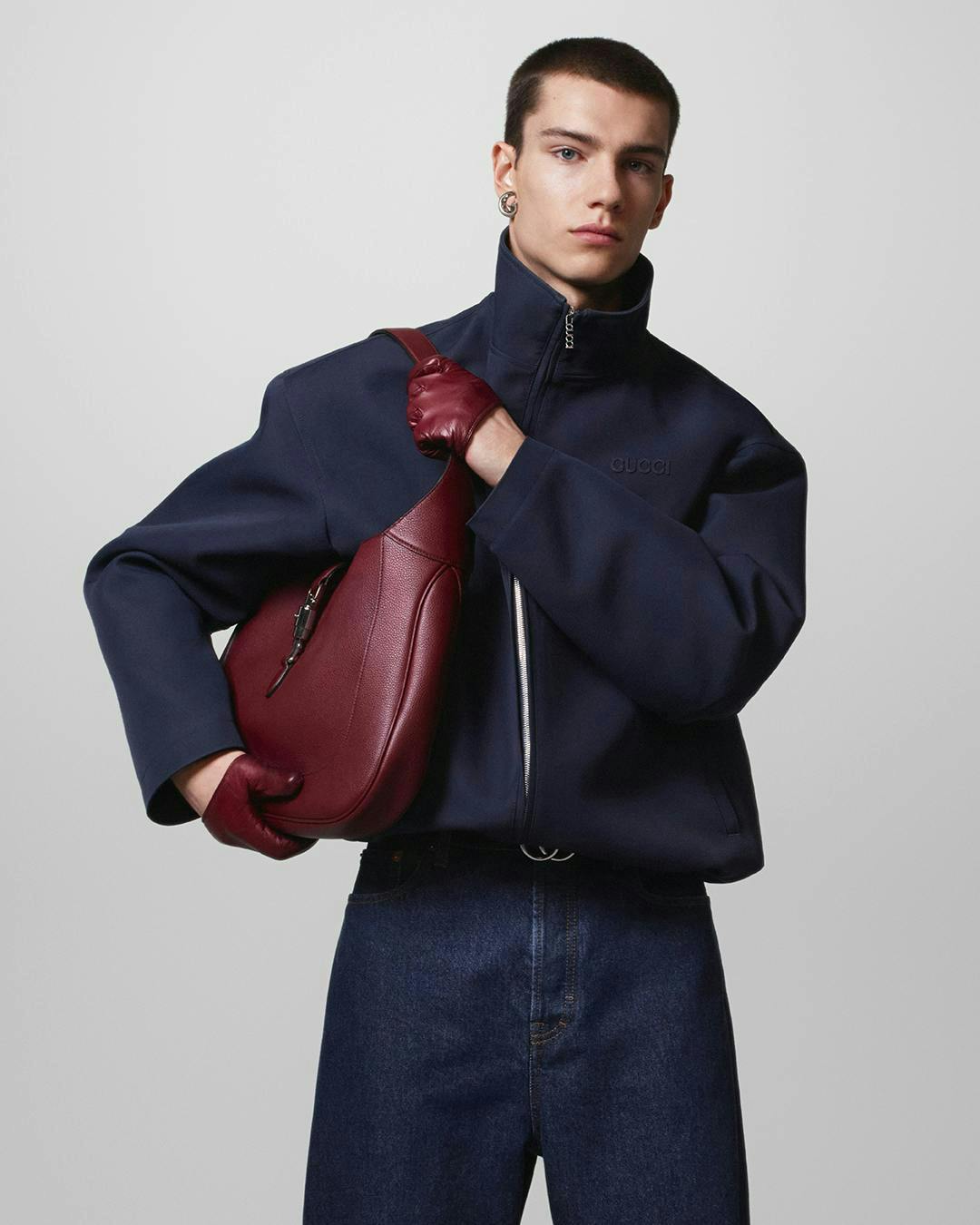 coat jacket blazer adult male man person handbag formal wear glove