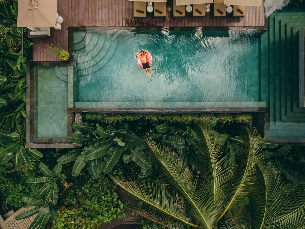 hands,ring,caucasian,aerial,float,inflatable,view,donut,poolside,resort,day,lying,overhead,pleasure,destinations,relaxation,relaxing,pool,floatie,lifestyles,water,retreat,idyllic,person,male,behind,young,tourism,holiday,summer,head,tourist,trunks,swimming,hotel,vacation,exotic,man,leisure,resting,top view,nature,one,people,tropical,outdoors,luxury,travel,villa summer pool water swimming pool hotel resort person swimming outdoors plant